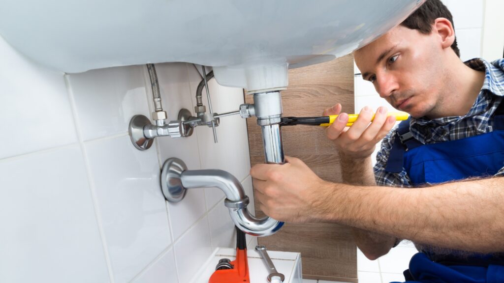 Emergency plumber repairing burst pipe in Vancouver home